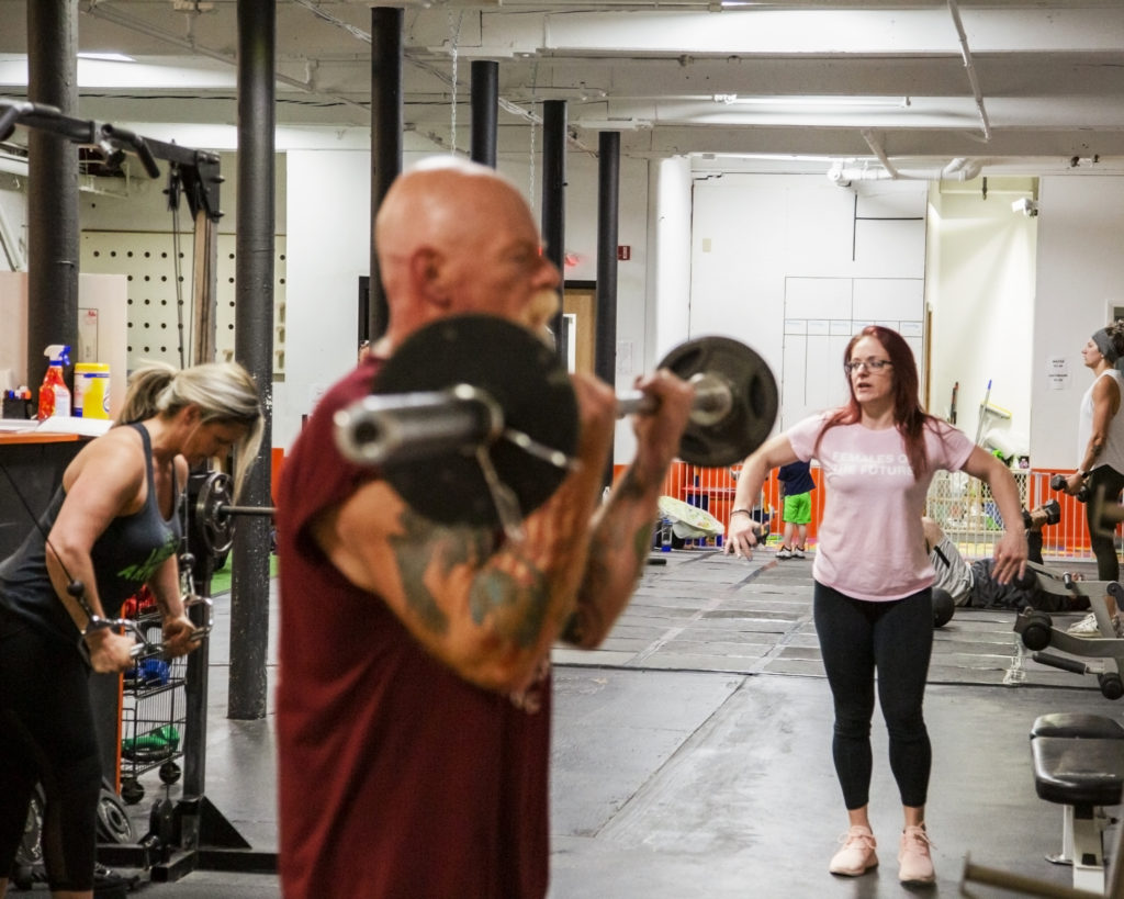 Menagerie Photography Studio Celebrating Local Women In Business Featuring Lauren Nadwairski Gym Coach Trainer man lifting weights