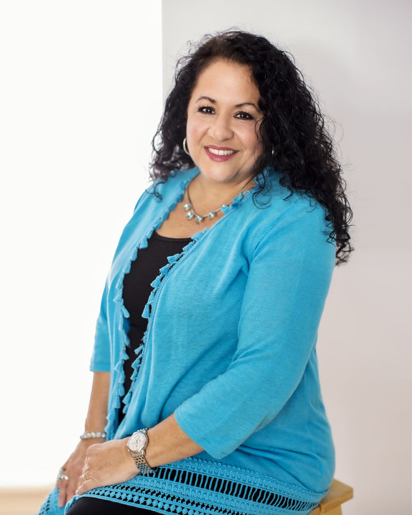 Celebrating Local Women In Business Featuring Pam Patalano headshot in blue sweater